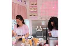 Image Two women at the Oatly pop-up in Amsterdam putting toppings on ice cream.